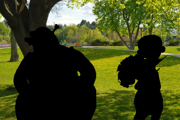 Mysterious figures in a park.